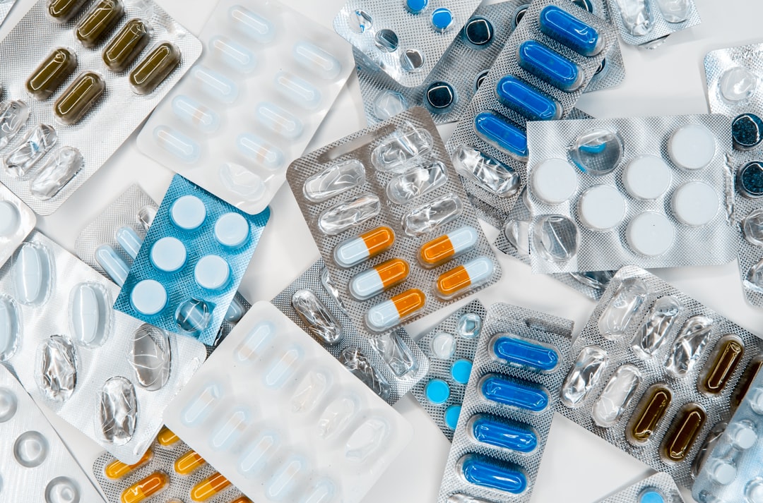 Photo by Roberto Sorin a pile of pills sitting next to each other on top of a table